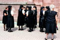 Worshippers in traditional dress gathering outside Sankt Peter church after Mass. Sankt Peter, Germany.
