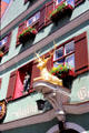 Guest house with statue of golden deer on heritage building in historic center. Dinkelsbühl, Germany.