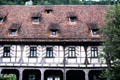 Half-timbered building with tiled slopped roof & dormer windows at Blaubeuren Abbey. Blaubeuren, Germany.