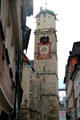 Gothic bell tower of St Martin Lutheran church with more modern clock fixed to exterior. Memmingen, Germany.