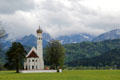 St Coloman baroque church in Schwangau in pastoral setting with Alps in background. Füssen, Germany.