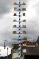 Maypole in Hohenschwangau with directions signs to nearby attractions. Füssen, Germany.