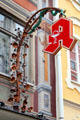 Ornate metal work with dragon holding pharmacy sign on Stadt-Apotheke on Reichenstrasse 12. Füssen, Germany.