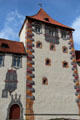 Tower with peaked tiled roof & multi-colored trim at Hohes Schloss zu Füssen. Füssen, Germany.