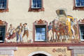 Stagecoach & street scene paintings on exterior wall of guest house. Mittenwald, Germany.