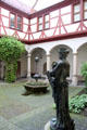 Cobblestone courtyard with statue at Ulmer Museum. Ulm, Germany.