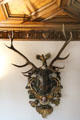 Wall mounted carved hunting trophy with real antlers at Ulmer Museum. Ulm, Germany.