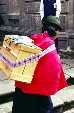 Native woman using traditional carrying method in Quito. Ecuador.