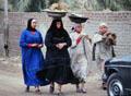 Women carrying baskets on heads in Giza. Egypt.