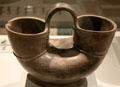 Tairona culture ceramic double-mouth vessel with stirrup handle from Colombia at Museum of America. Madrid, Spain.