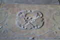Skull & crossbones carving on floor of at Barcelona Cathedral. Barcelona, Spain.