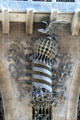 Decoration of bird atop crown atop spiral pole between entrance doors at Palau Güell. Barcelona, Spain