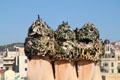 Chimneys decorated with bottle glass atop Casa Milà. Barcelona, Spain.