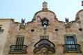 Gable with owner's family sculptures & Gaudí's ironwork designs atop Casa Calvet. Barcelona, Spain.