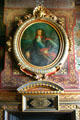 Detail of fireplace with portrait & clock in Chateau. Ancy-la-Franc, France