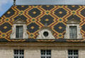 St Louis facade & tiled roof in courtyard of Hotel Dieu. Beaune, France.