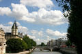 Clouds over Seine River & Tribunal Judiciaire tower on Quai des Orfèvres. Paris, France.