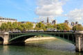 Pont Notre-Dame iron arch bridge with city hall towers beyond. Paris, France