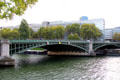 Pont de Sully cast-iron arch bridge with Arab World Institute beyond. Paris, France.