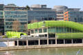 Buildings along Quai d'Austerlitz with green tubing facade on River Seine. Paris, France.