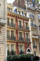 Residential building in brick with white quoins in 16th arrondissement. Paris, France.
