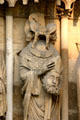Statue of St. Denis holding his severed head on Cathedral. Reims, France.