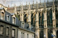 Flying buttresses of Cathedral seen against houses. Reims, France.