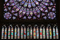 Rose window of Virgin & Child circle by old testament figures over vertical windows of kings in north transept of Notre Dame Cathedral. Paris, France.
