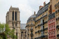 Rue Lagrange streetscape on Left Bank with building facades & Notre Dame church towers beyond. Paris, France.