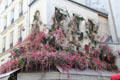 Hotel decorated with floral hangings on Rue de Buci in Latin Quarter. Paris, France.