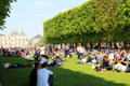 Summer crowds sunning in Luxembourg Gardens. Paris, France.