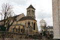 Apse end of Paroisse Saint-Pierre de Montmartre church with Montmartre water tower beyond. Paris, France.