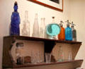 Antique liquor bottles & glassware at Montmartre Museum. Paris, France.