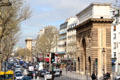 Streetscape of Parisian boulevards between Port St.-Martin & Port St.-Denis in distance. Paris, France.