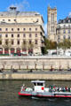 Théâtre de la Ville & Tour St Jacques over tour boat on River Seine. Paris, France