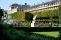 Statues & flowers in garden at Palais Royale. Paris, France.