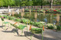 Reclining chairs beside pond in Tuileries Garden. Paris, France.