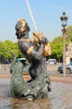 River creature holding squirting fish detail of Fountain of Rivers by Jacques Ignace Hittorff in northern position on Place de la Concorde. Paris, France