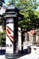 Cylindrical advertising column has evolved on streets of Paris since c1870 on Champs Elysees. Paris, France.