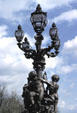 Iron lamppost with cherubs on Alexandre III bridge. Paris, France.