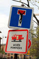 Dead-end street sign appended with crucified figure. Paris, France.