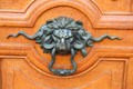 Lion door knocker on Paris gront door. Paris, France.