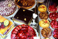 Rows of cakes & tarts at pastry shop. Paris, France.