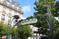 Details of Metropolitain sign & flower lights of Paris Metro entrance. Paris, France.