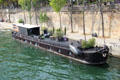 Houseboat on Seine with leisure garden on deck. Paris, France.