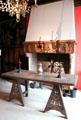 Oak trestle table in room with 15thC fireplace & objects at Museum of Decorative Arts. Paris, France