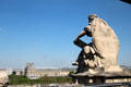 Statues atop Musée d'Orsay with Louvre beyond. Paris, France.