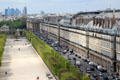 Arcades of rue de Rivoli with highrises of La Defense beyond seen from Louvre Palace. Paris, France.