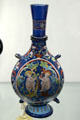 Enameled blue glass gourd with figures from Venice at Louvre Museum. Paris, France.