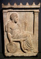 Funerary stela of bronze smith Sosinos of Gortyn seated with bellows in right hand from Mount Pentelikon near Athens at Louvre Museum. Paris, France.